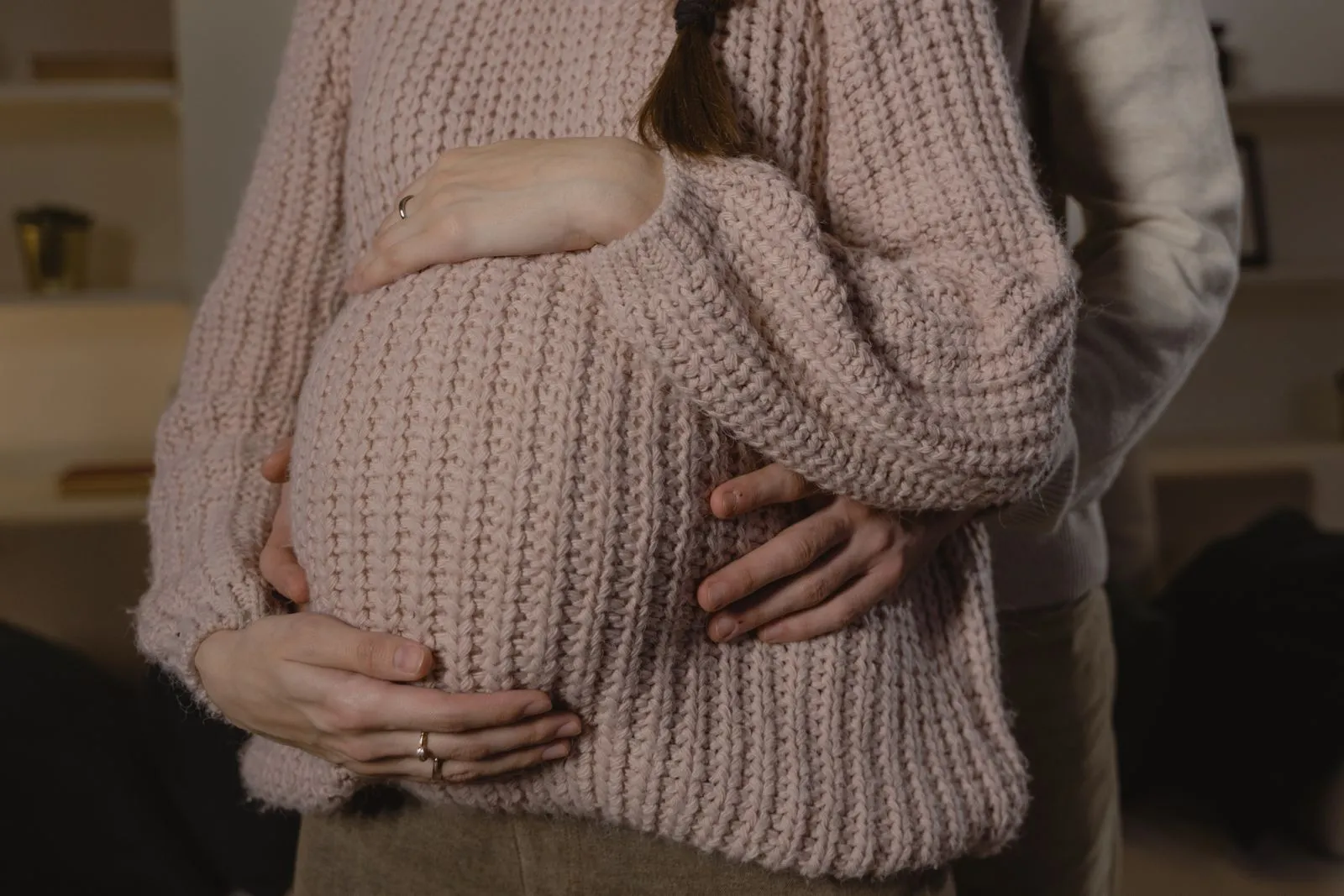 Close-up of a loving couple embracing during pregnancy, highlighting warmth and intimacy.
